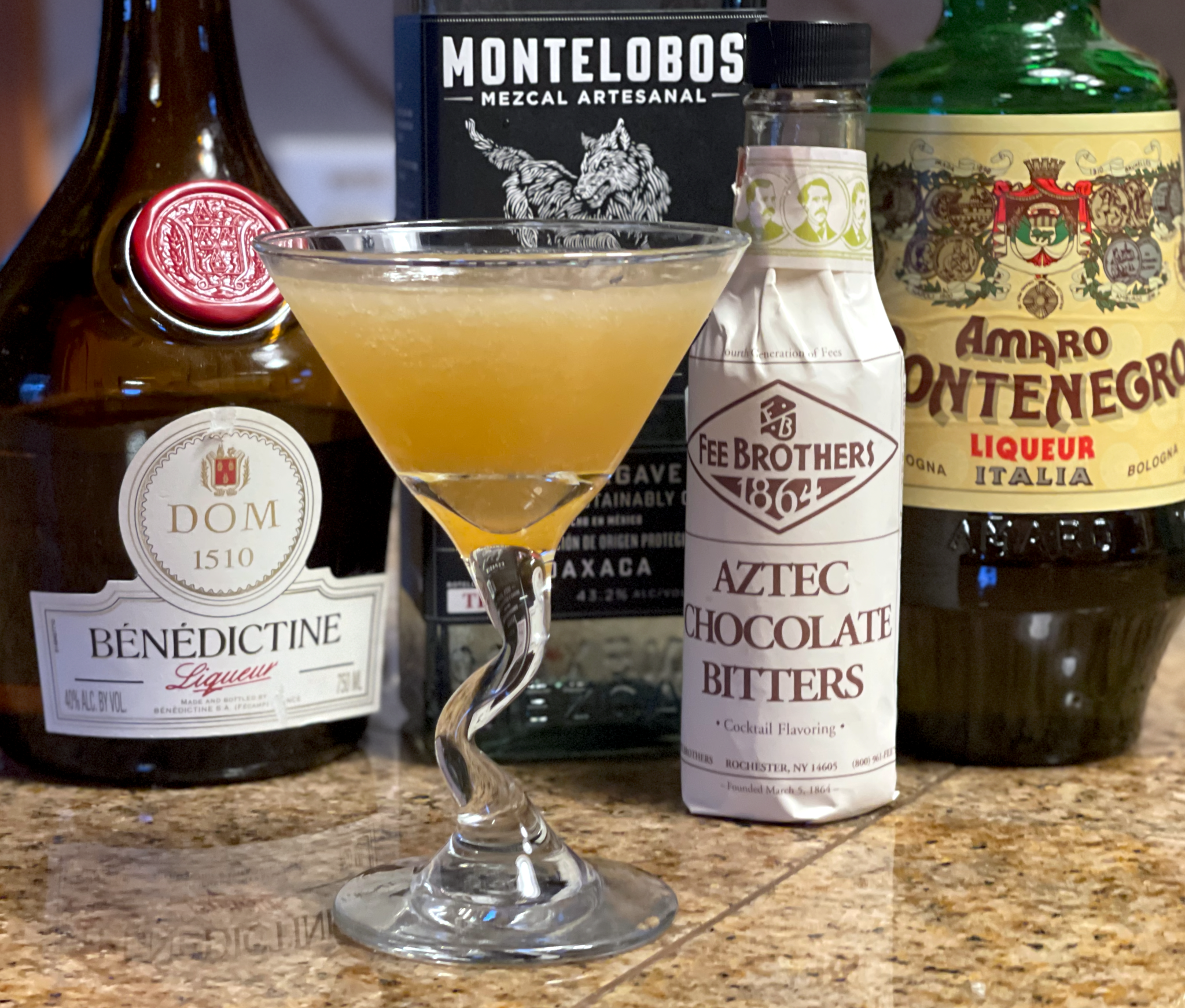 Oaxacan Lady cocktail: a yellow colored cocktail in a glass